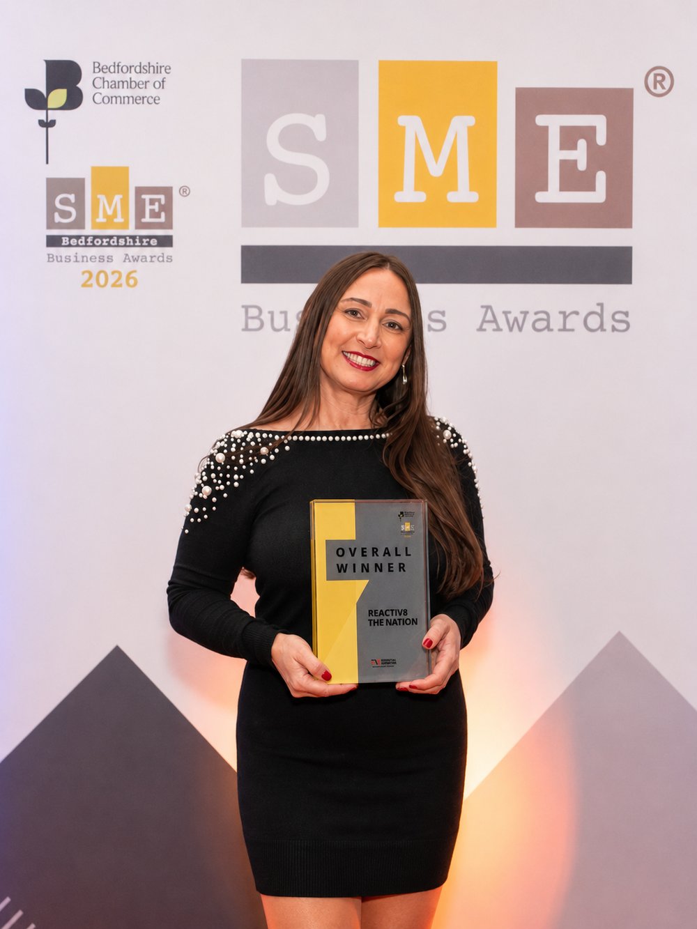 Michelle Crook holding the Overall Winner trophy at the SME Bedfordshire Business Awards 2026