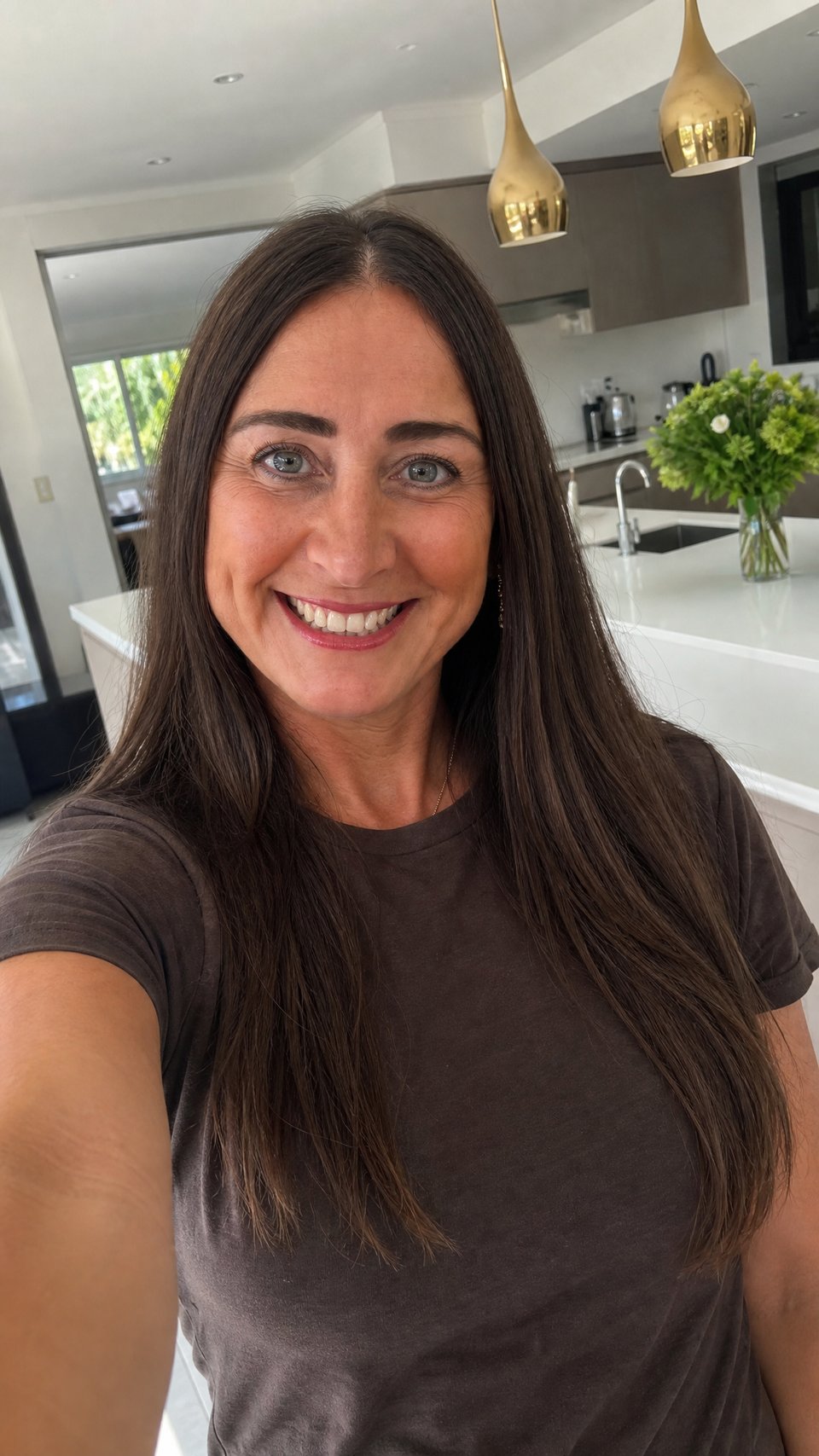 Michelle Louise Crook smiling in her kitchen, taking a selfie
